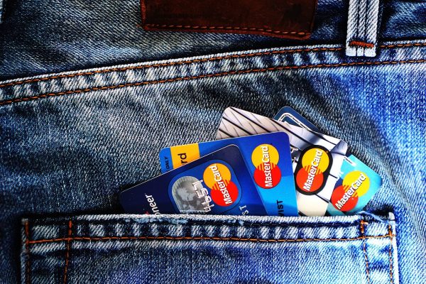 Credit cards, debit cards, and money are important. Denim and blue jeans are popular clothing choices. A bank account helps manage your money. Mastercard is a well-known credit card. You can keep cards in your pocket. Banks play a key role in handling money